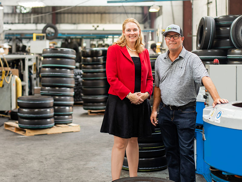 Two people standing in a tire warehouse